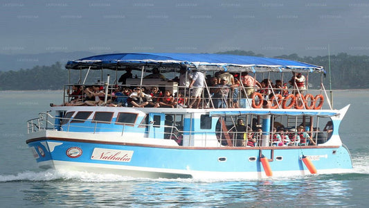 A boat full of people heads out to sea for a whale watching tour in Hikkaduwa, Sri Lanka.
