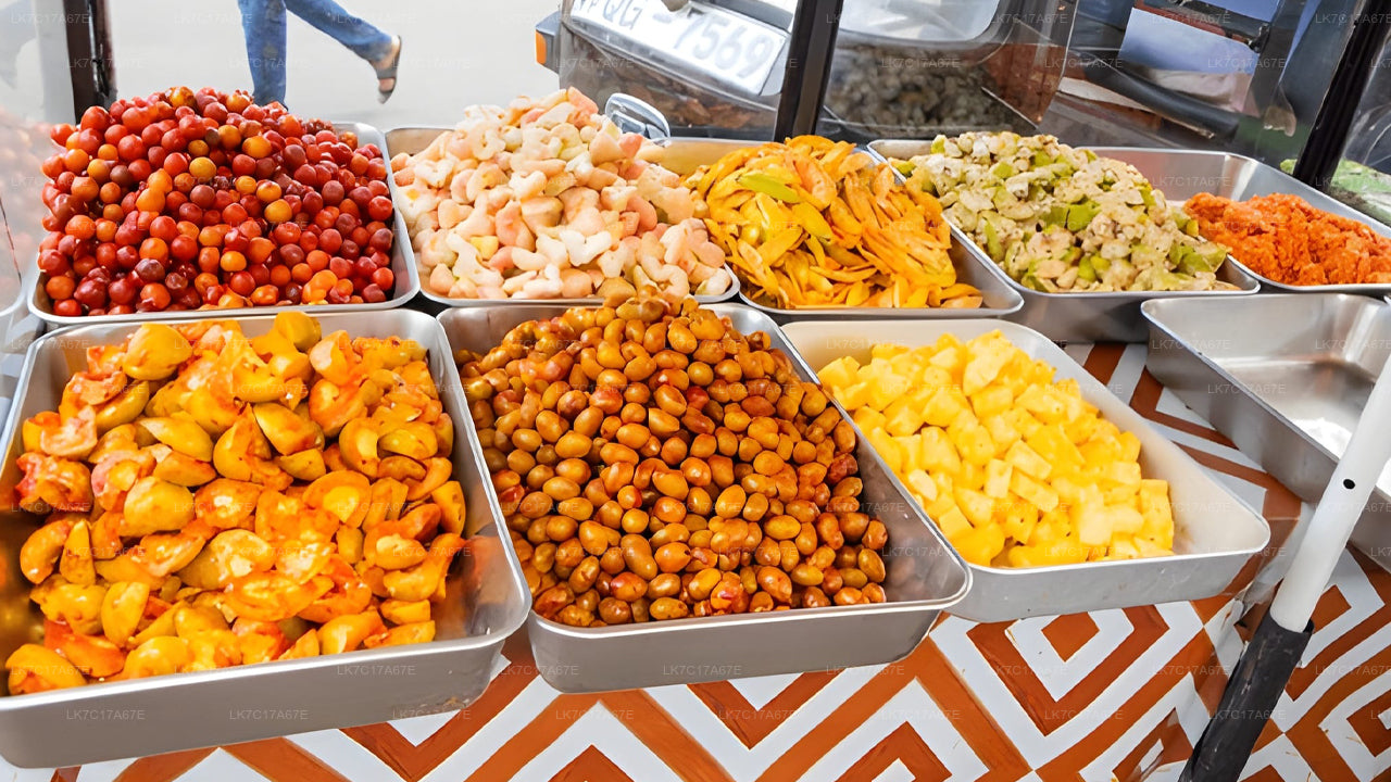Assorted snacks in metal trays on a patterned tablecloth